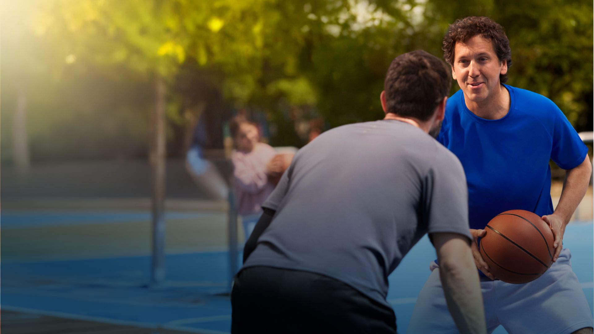 Actor portrayal of a Camzyos® (mavacamten) patient and a friend playing basketball.