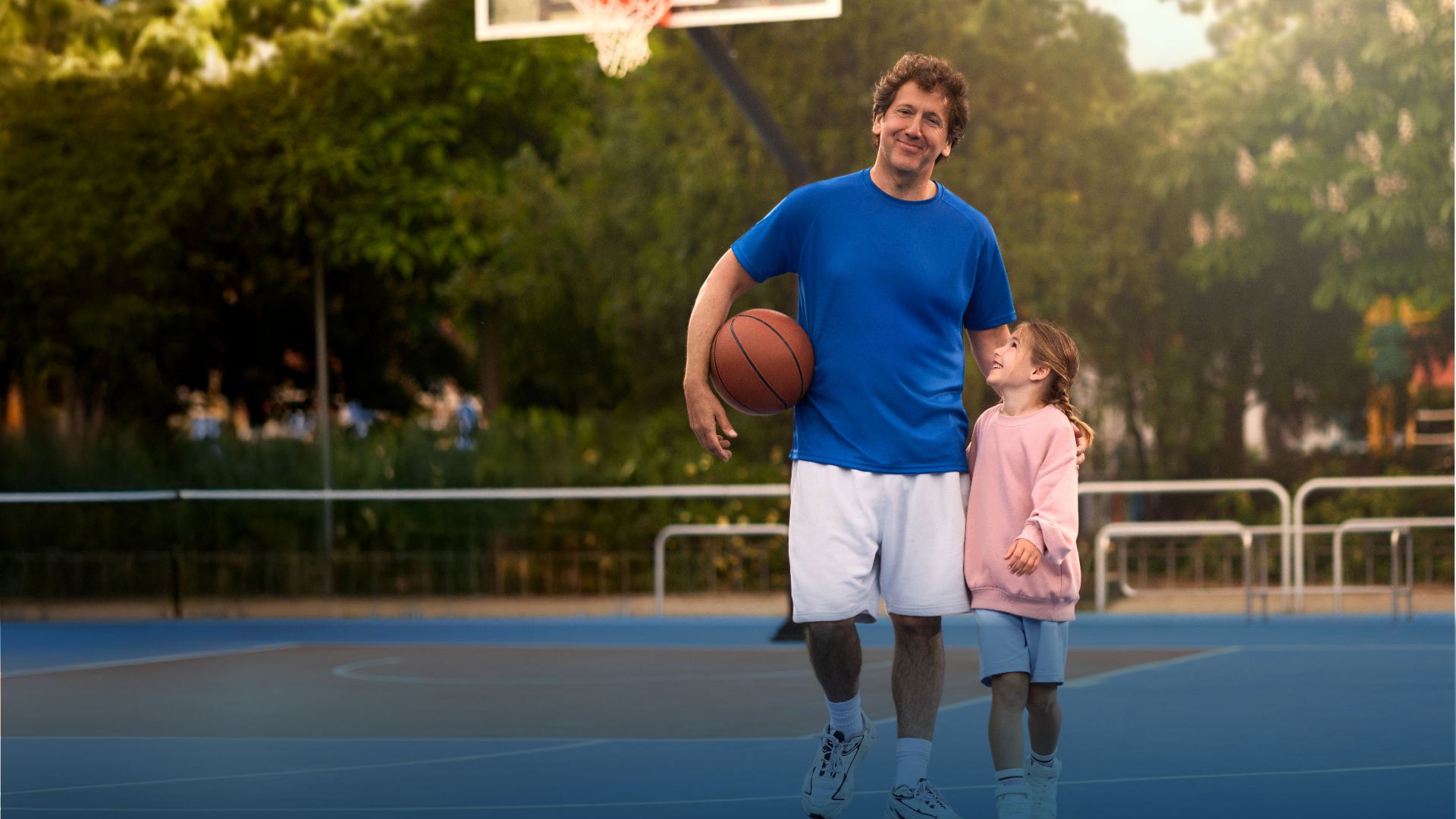 Actor portrayal of a Camzyos® (mavacamten) patient and a young girl walking on a basketball court.