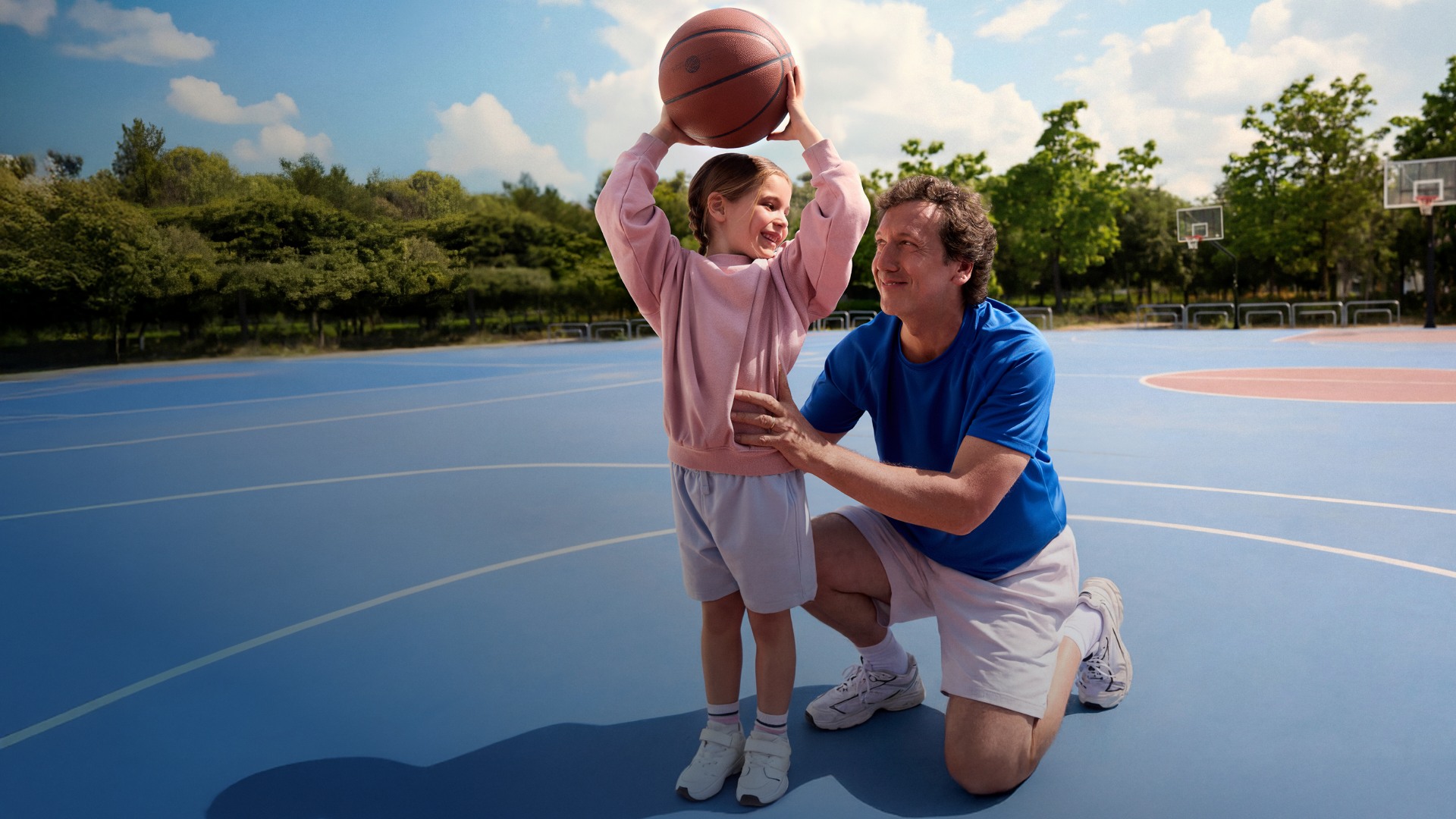Actor portrayal of a CAMZYOS® (mavacamten) patient helping a child play basketball.