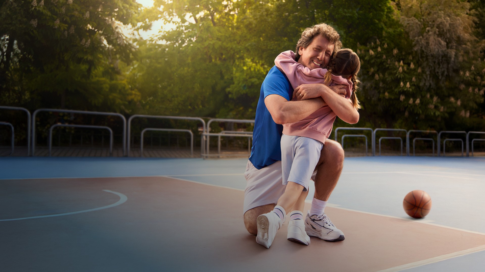Actor portrayal of a CAMZYOS® (mavacamten) patient hugging a child.