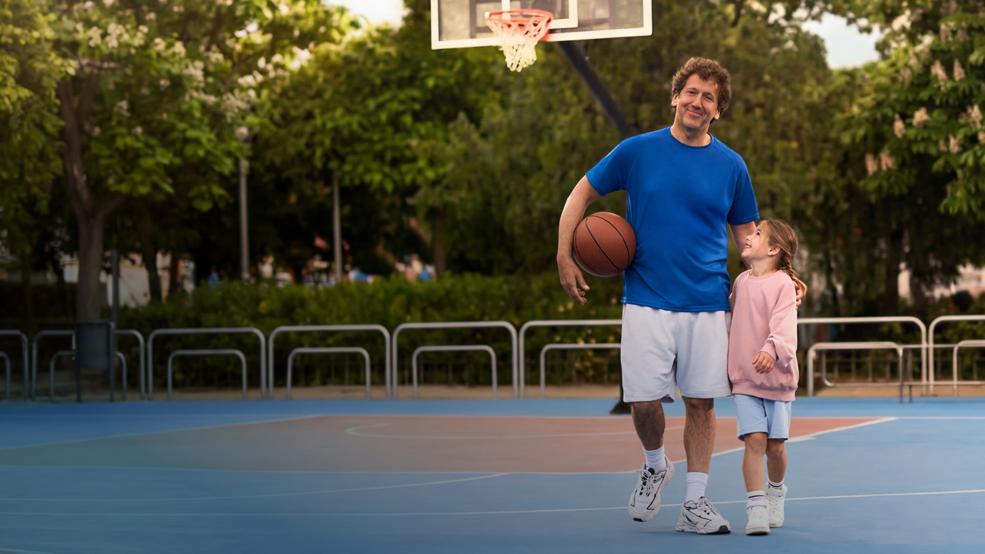 Actor portrayal of a CAMZYOS® (mavacamten) patient standing with a child.