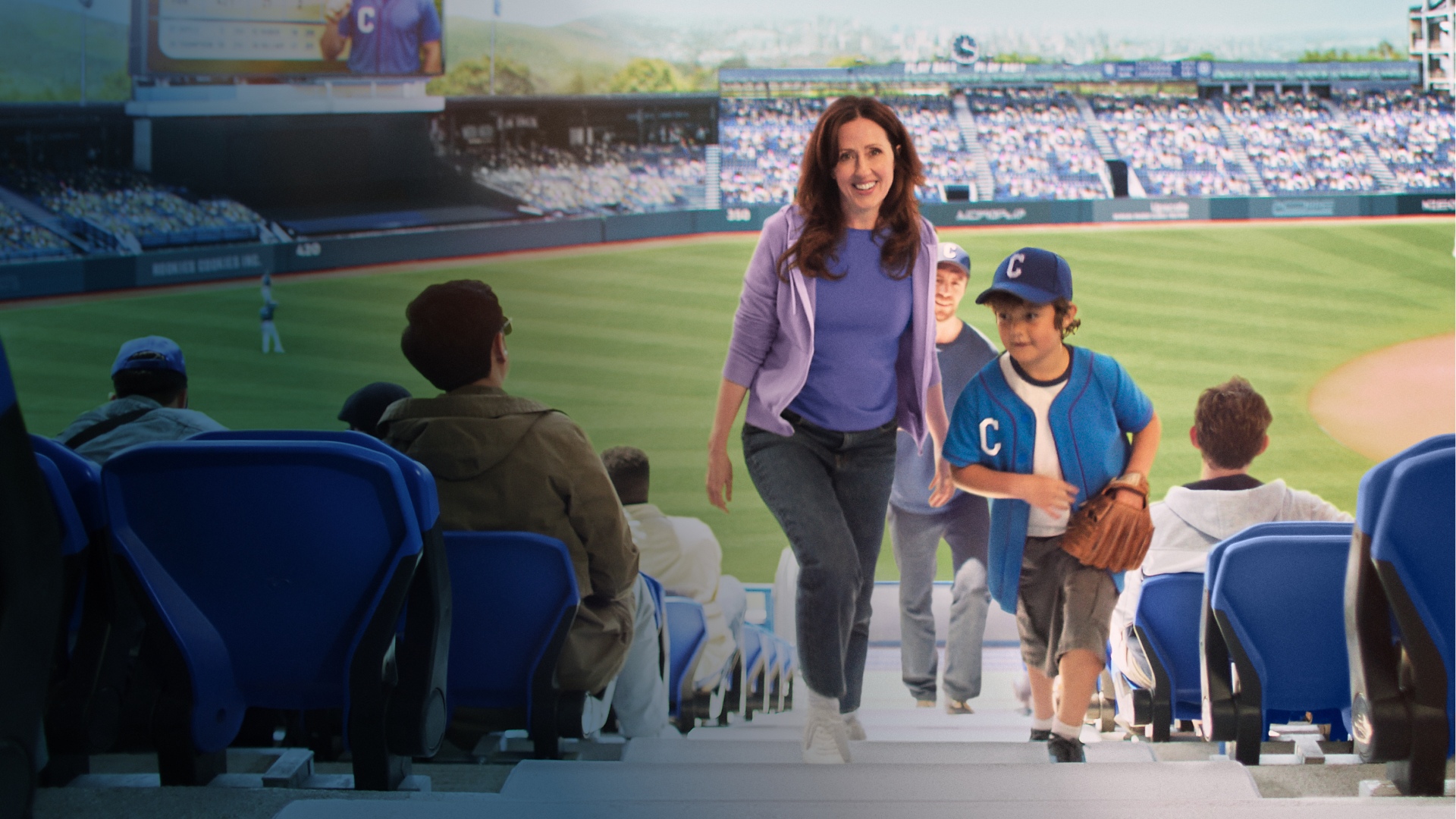 Actor portrayal of a CAMZYOS® (mavacamten) patient walking up the stairs at a baseball stadium with a young boy.