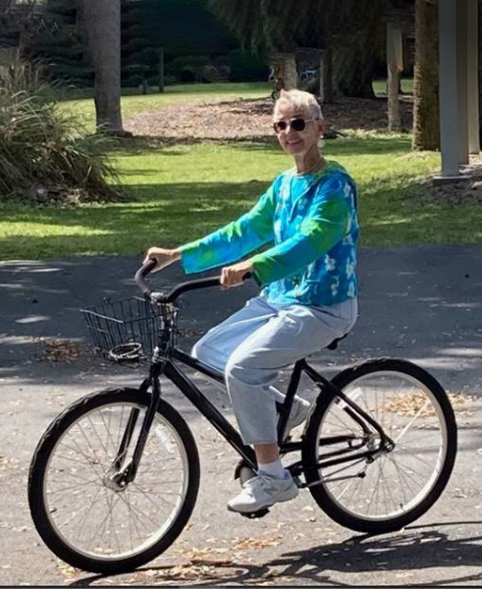 Rebecca, a Rx CAMZYOS® (mavacamten) patient, riding her bike