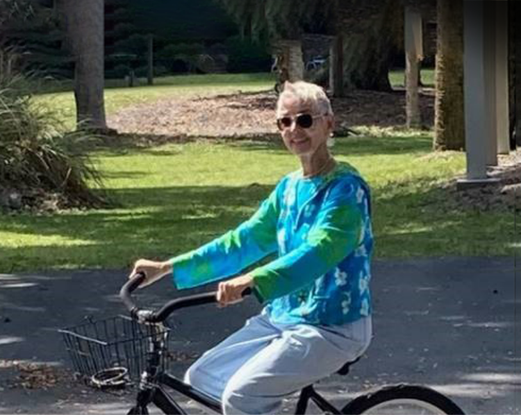Rebecca, a Rx CAMZYOS® (mavacamten) patient, riding her bike