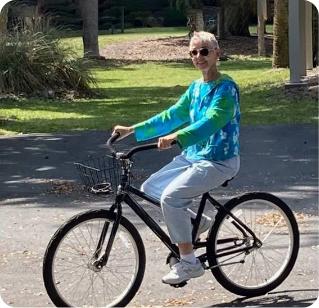 Rebecca, a Rx CAMZYOS® (mavacamten) patient, riding her bike